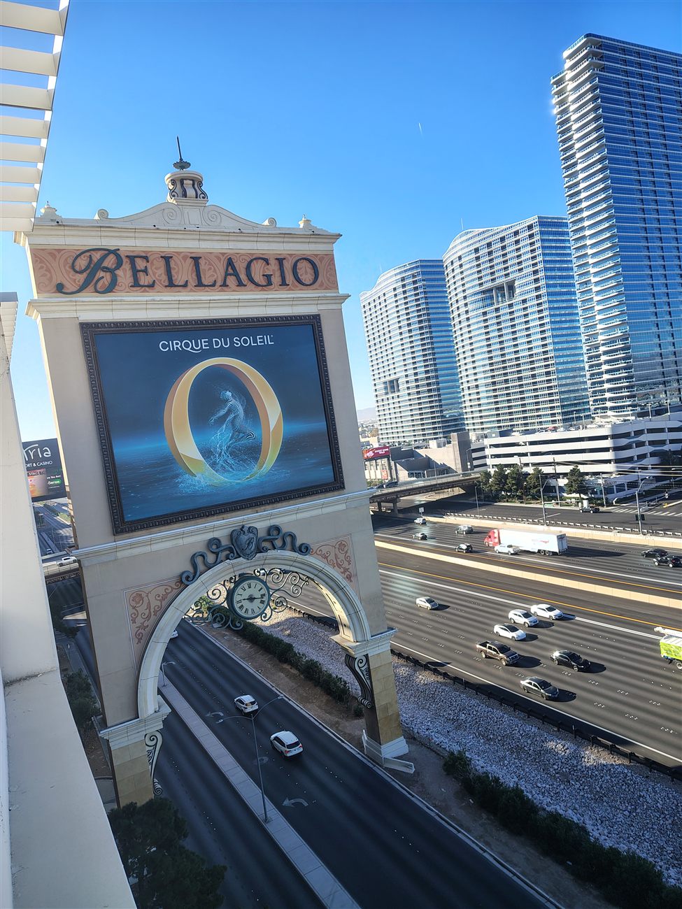 The Bellagio sign and clock tower under a clear blue sky