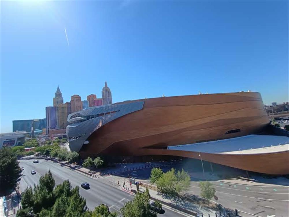 The wood-clad curved exterior of a modern arena building