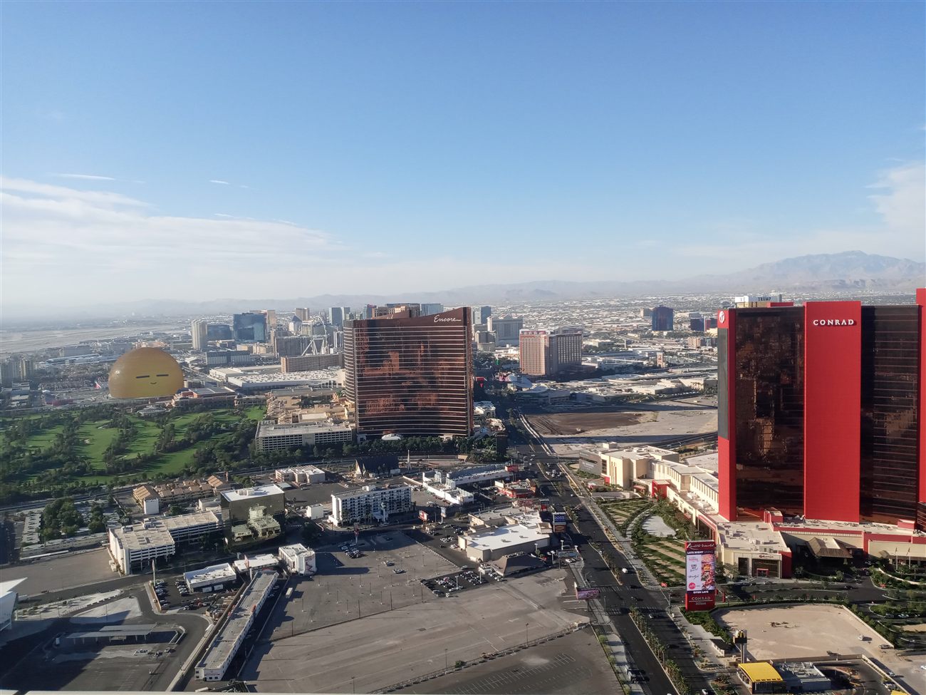 Aerial view of the Conrad hotel with mountains in the background