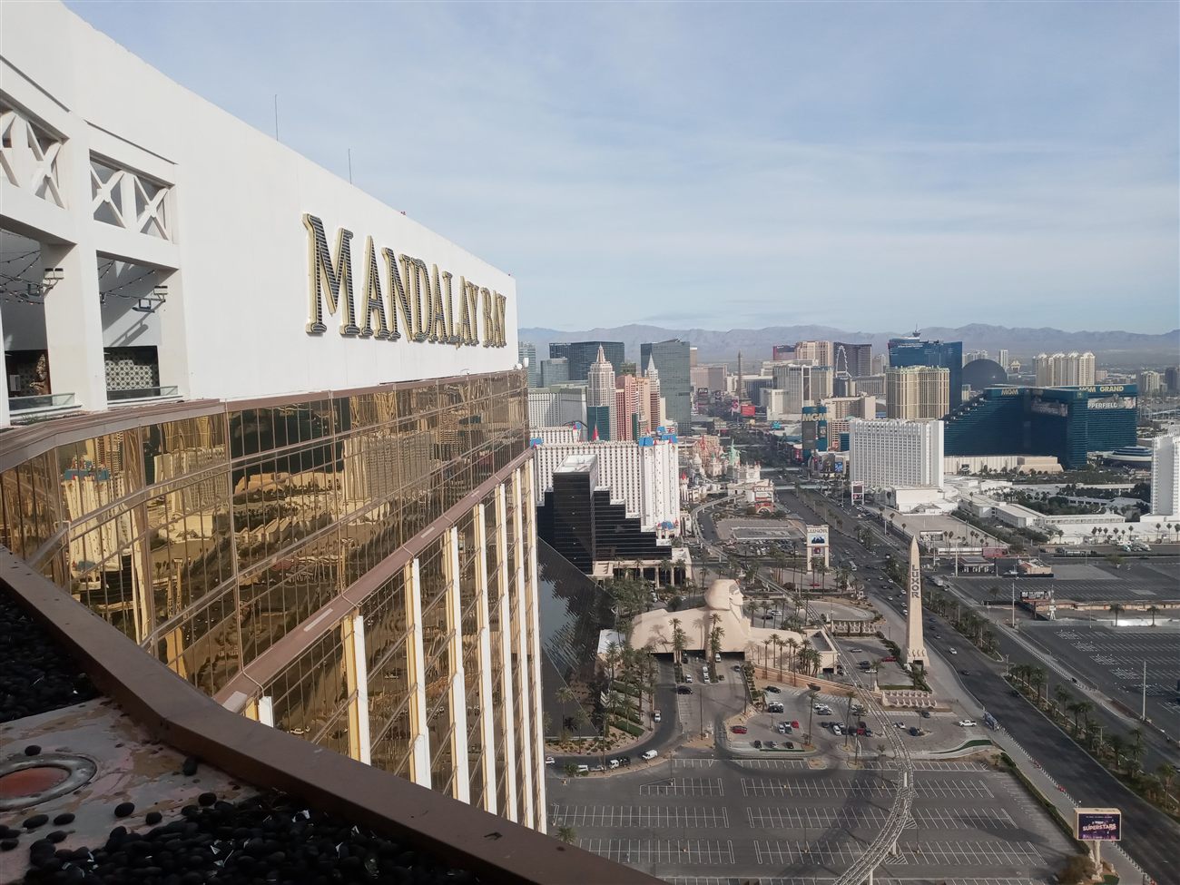 The Mandalay Bay sign with the full Strip skyline behind it