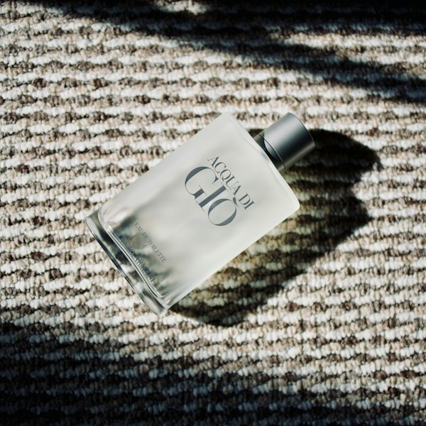 A bottle of Giorgio Armani Acqua di Gio Eau de Toilette on a textured surface